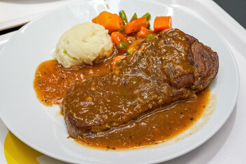 A delicious western-style meat sauce steak with mashed potatoes