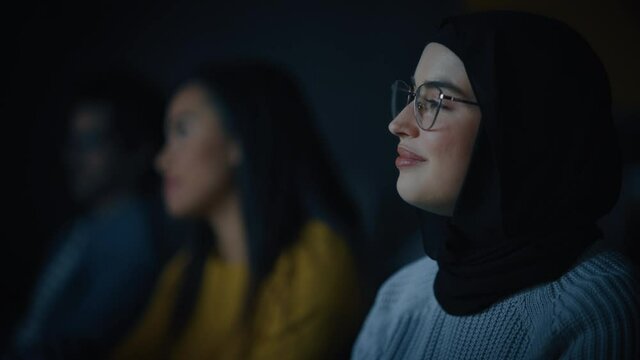 Beautiful Close Up Portrait of a Multiethnic Muslim Female Wearing Hijab and Glasses, Charmingly Smiling and Posing on Camera. Happy Diverse Young Woman in Casual Clothes Indoors.