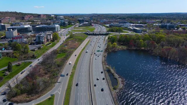 Flying over Interstate Highway 95 I-95 and Cambridge Reservoir in spring in city of Waltham, Massachusetts MA, USA. 
