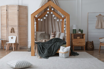 Obraz na płótnie Canvas Stylish child room interior with wooden house bed