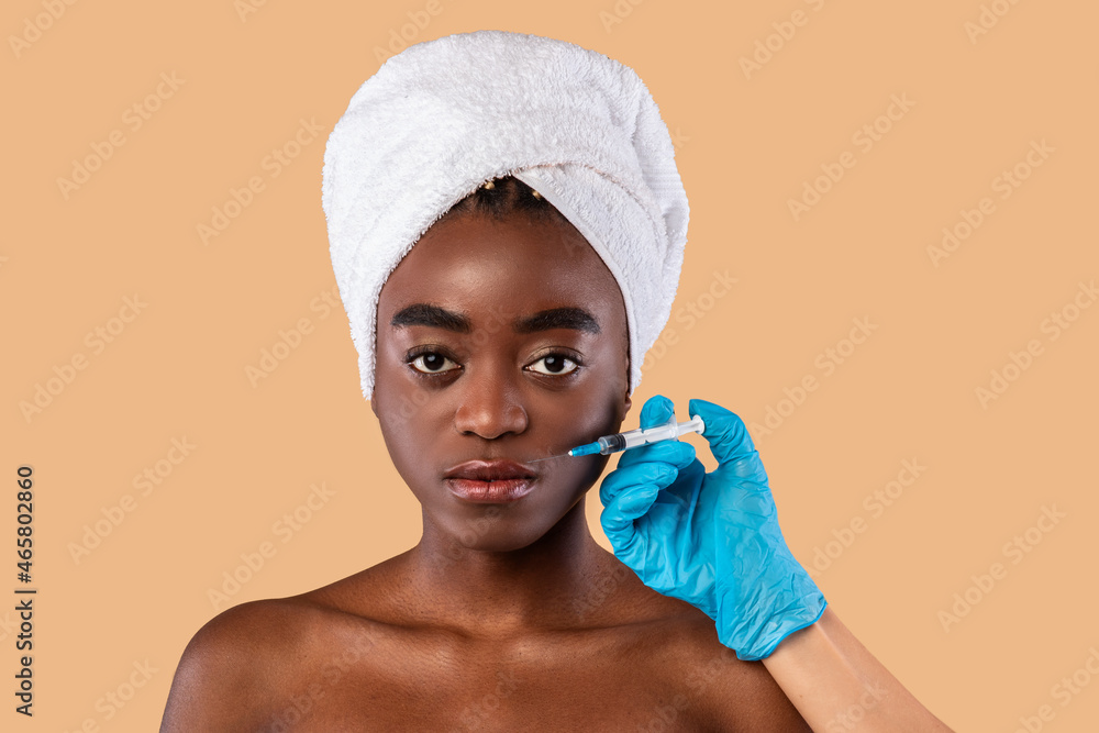 Wall mural black woman receiving lip augmentation beauty injection