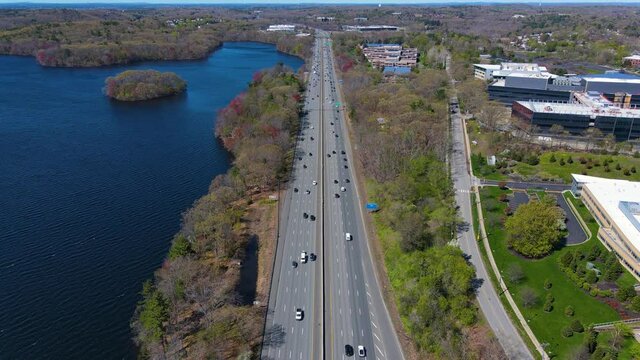 Flying over Interstate Highway 95 I-95 and Cambridge Reservoir in spring in city of Waltham, Massachusetts MA, USA. 