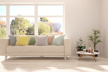 Stylish room in white color with sofa and autumn landscape in window. Scandinavian interior design. 3D illustration