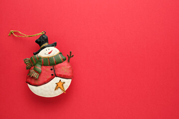 snowman ornament on red background