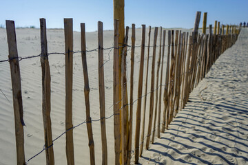 Wooden post fence on a sandy beach