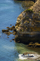 low tide, rocks and cliff to the beach Praia do Camilo, in Lagos, Algarve, Portugal