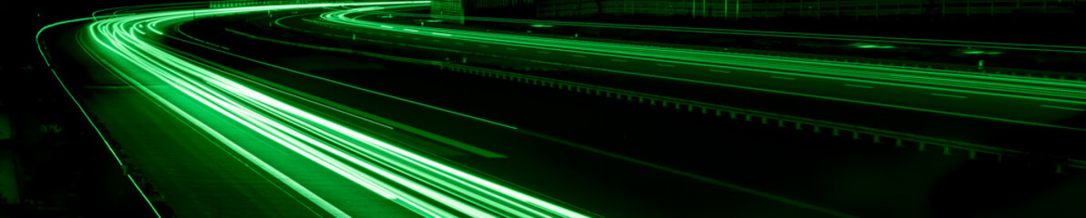 green car lights at night. long exposure - obrazy, fototapety, plakaty
