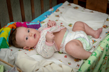 cute little baby girl lying in a crib