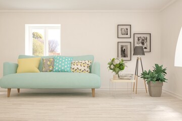 Stylish room in white color with sofa and autumn landscape in window. Scandinavian interior design. 3D illustration