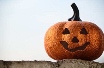 halloween jack lantern pumpkin on autumn leaves against the dark night sky at sunset. happy...