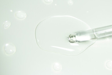 Liquid gel or serum on a microscope screen on a white background