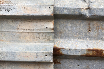 Old gray corrugated metal fence with rust spots