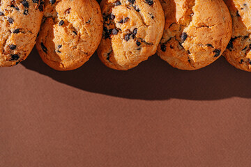 chocolate chip cookies close-up on brown background