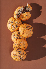 chocolate chip cookies close-up on brown background
