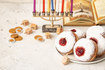 Tasty donuts with jam on background - Hanukkah celebration concept	