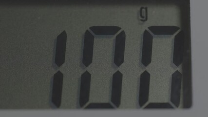 electronic scales display showing one hundred grams