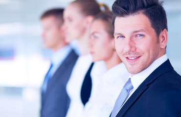 Smiling successful business team standing in office