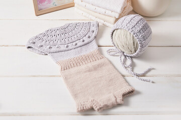 Knitted kids clothes and accessories for knitting. Needlework and knitting. Hobbies and creativity....