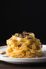 Tagliatelle pasta with black truffle mushrooms. Tagliatelle al tartufo - Italian autumn fresh recipe with black truffle, rustic style, copy space, close-up