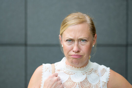 Angry petulant blond woman glaring at the camera