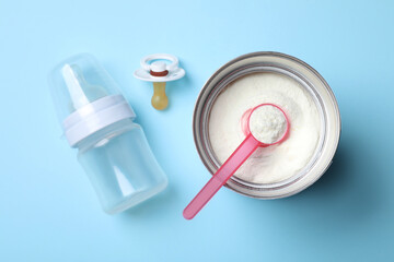 Flat lay composition with powdered infant formula on light blue background. Baby milk - obrazy, fototapety, plakaty