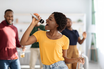 Closeup of pretty african american woman singing karaoke