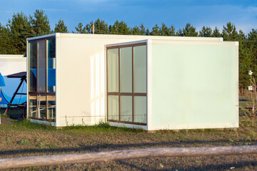 Modular frame house with panoramic windows on the edge of a pine forest. Mass production according to a non-individual project of a modular building.