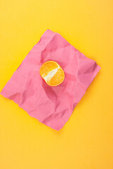 Composition of limns, tangerines and oranges on a pink background.