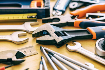 DIY, maintenance service works concept. Home repair tools set on wooden background.