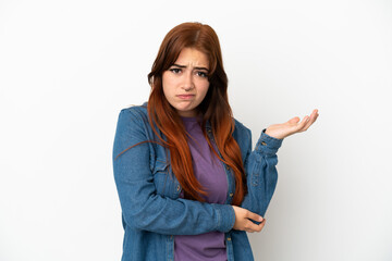 Young redhead woman isolated on white background having doubts