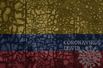 flag of colombia on a old metal rusty cracked wall with text coronavirus, covid, and virus picture.
