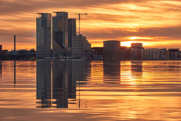 View of the first skyscrapers in Finland in the Kalasatama neighborhood of Helsinki on the sunset background. Modern Nordic architecture.