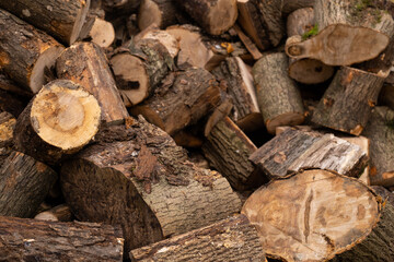 Rural life. Near the fence there is a large pile of birch firewood. Natural background of firewood.