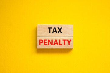 Time to tax penalty symbol. Concept words Tax penalty on wooden blocks on a beautiful yellow background. Business and tax penalty concept. Copy space.