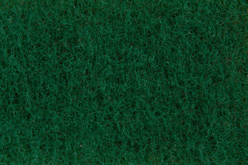 background of green sponge for washing dishes, close-up, porous surface