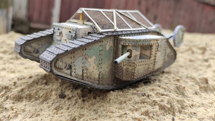 An English toy tank from the First World War. Mark I, the combat vehicle moves on the sand. Simple paper toys for children.
Modeling, collecting, education, historical concepts