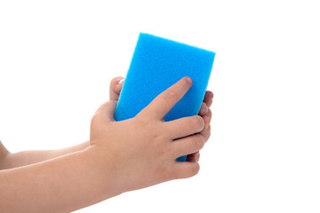hands of a child with a cleaning sponge in blue on a white background, close-up