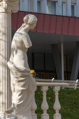 Antique sculptural composition with a woman and a column