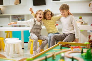 Group of kindergarten kid friends sitting and having fun
