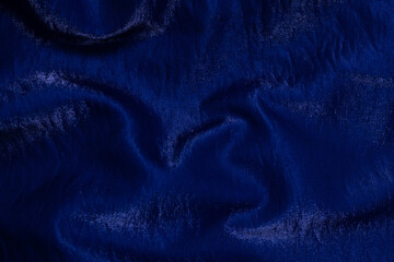 Purple shiny fabric as background. Top view.