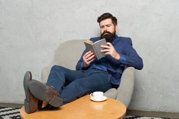 Time to read. Businessman read book relaxing in armchair. Rest break. Resting during work