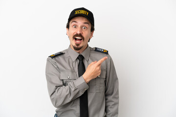 Young caucasian security man isolated on white background surprised and pointing side