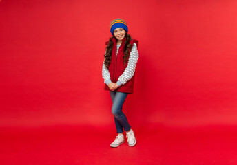 full length of child wearing warm clothes. express positive emotion. winter fashion.