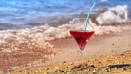 Wine glass with a cocktail by the sea.
