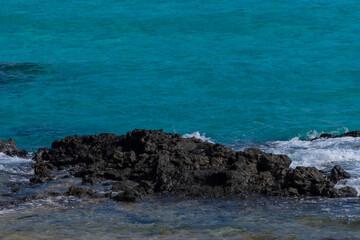 Fototapeta na wymiar Turquoise water of Atlantic ocean. Corralejo beach, Fuerteventura, Spain.