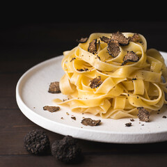 Tagliatelle pasta with black truffle mushrooms. Tagliatelle al tartufo - Italian autumn fresh...