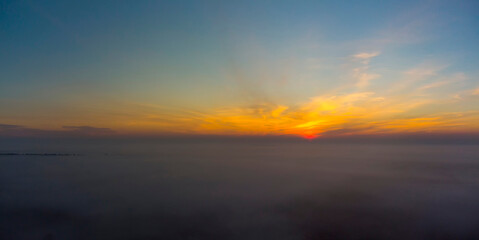 Fototapeta na wymiar Panorama of sunrise. Blue sky with orange clouds.