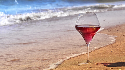 Wine glass with a cocktail by the sea.