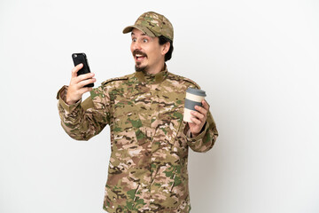 Soldier man isolated on white background holding coffee to take away and a mobile
