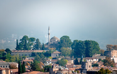 Fototapeta premium View of the fortified old city of Ioannina, Greece, in a foggy day, with the Alsan Pasha Mosque on top of the hill.